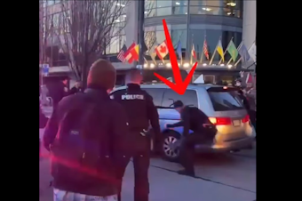 caption: A video on Instagram shows what appears to be a Seattle officer deflating the tire during a march last month.