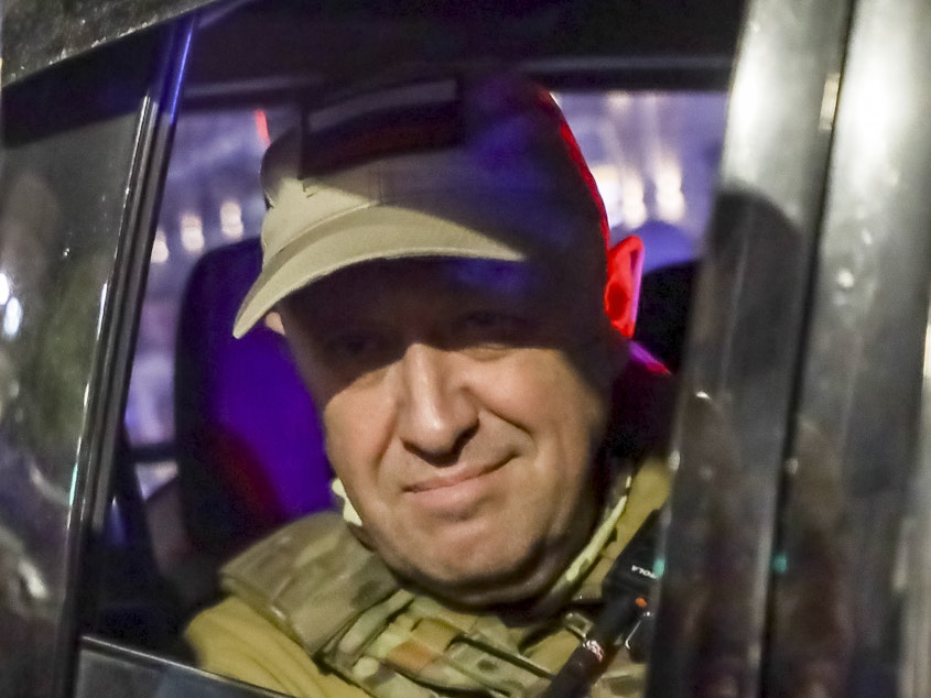 caption: Yevgeny Prigozhin, the owner of the Wagner Group military company, looks from a military vehicle leaving an area of the HQ of the Southern Military District in a street in Rostov-on-Don, Russia, on June 24.