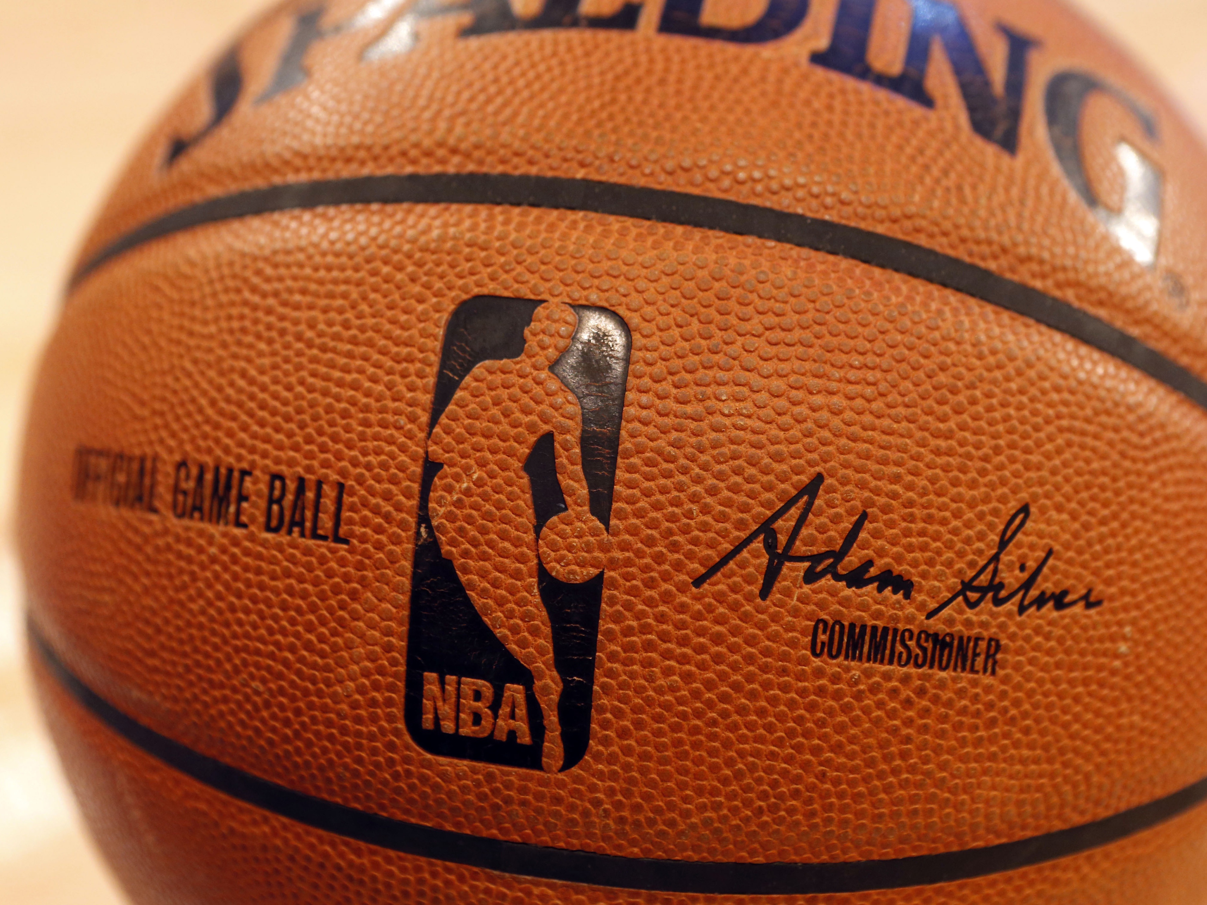 caption: An NBA logo is seen on an official game ball before a game, Feb. 1, 2014, in New York. The NBA said Wednesday that it is not accepting Warner Bros. Discovery's $1.8 billion per year offer to continue its longtime relationship with the league and therefore has entered into a deal with Amazon Prime Video.