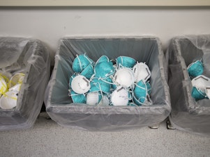 caption: Used N95 masks are collected at Boston's Massachusetts General Hospital on April 13, 2020. Hospital staff wrote their names on the masks so each could be returned after being cleaned, a strategy used to alleviate critical shortages of respirator masks.