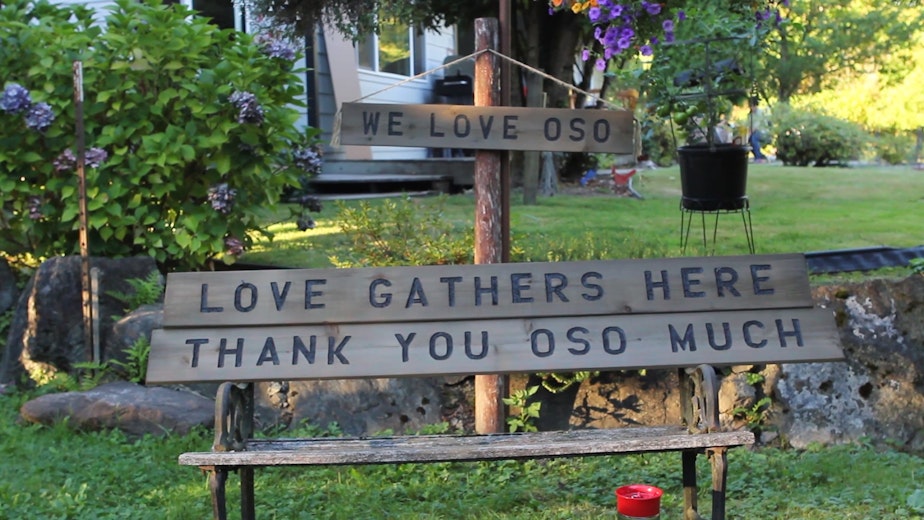 caption: Ron Thompson, whose home was destroyed in the Oso, Washington, slide, had a full workshop. He continues to carve signs, including these at his new home behind the Oso fire station. 