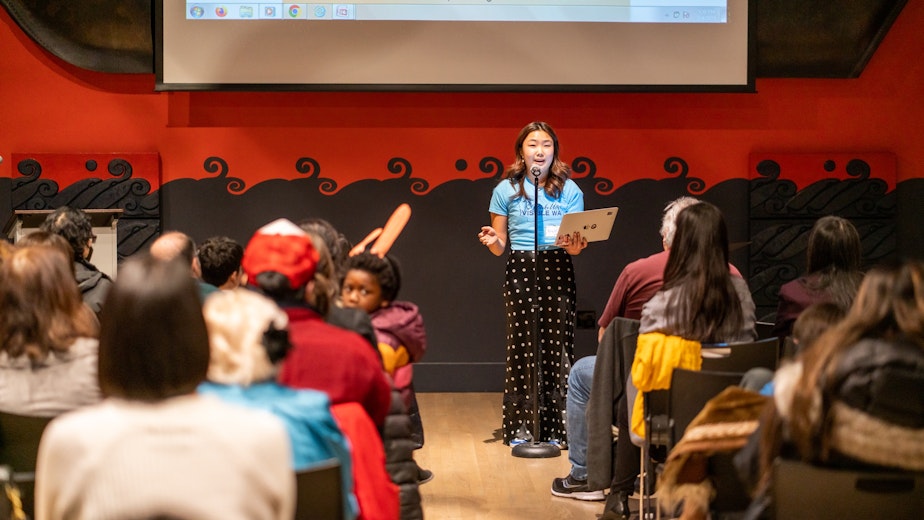caption: Brett Han, a senior at Seattle Academy, tells her story at Make Us Visible Washington's launch event on March 4 at the Wing Luke Museum in Seattle's International District.