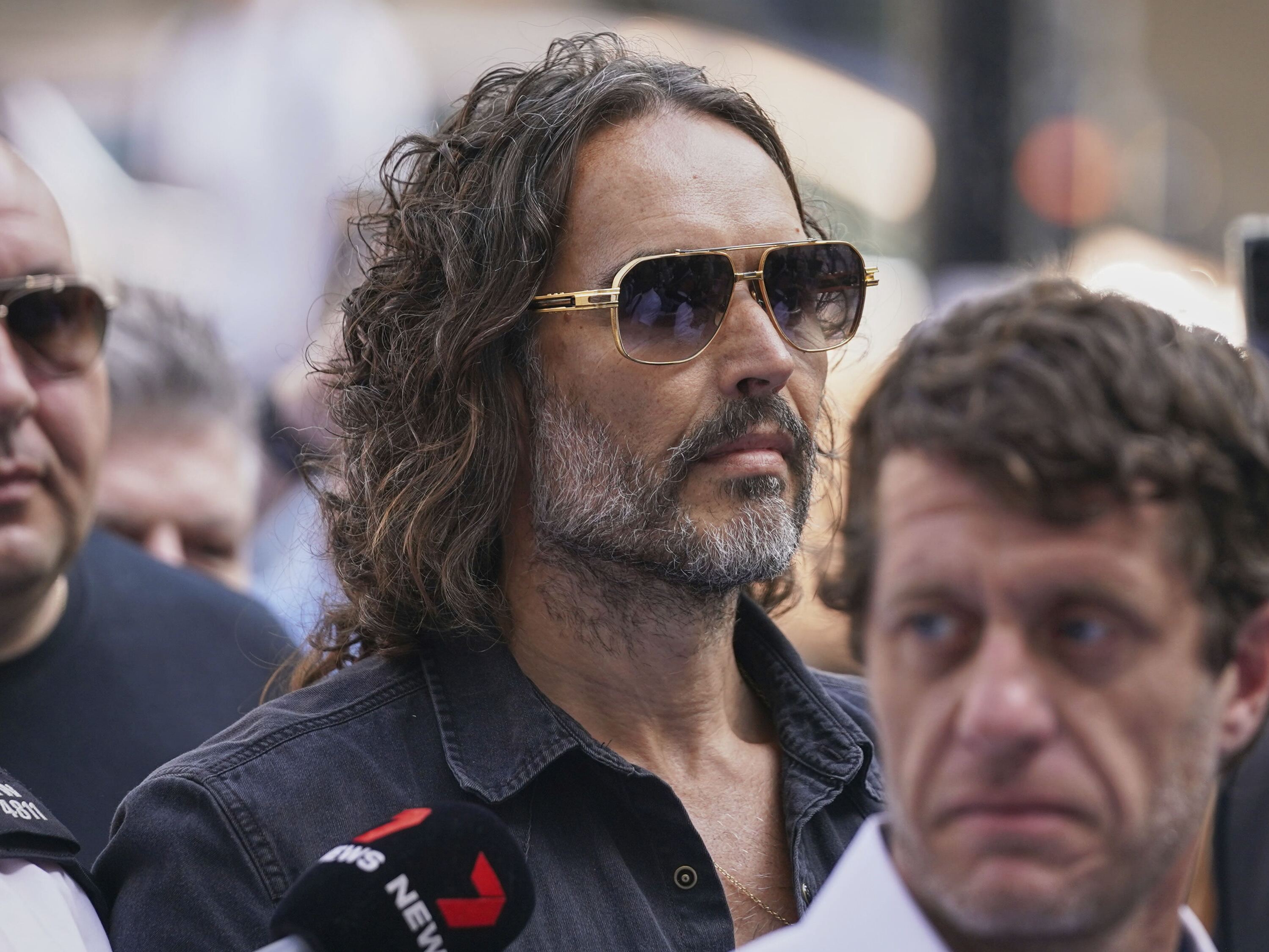 caption: Russell Brand arrives at Westminster Magistrates' court in London, Friday, May 2, 2025, where he faces, rape and sexual assault charges involving four women.