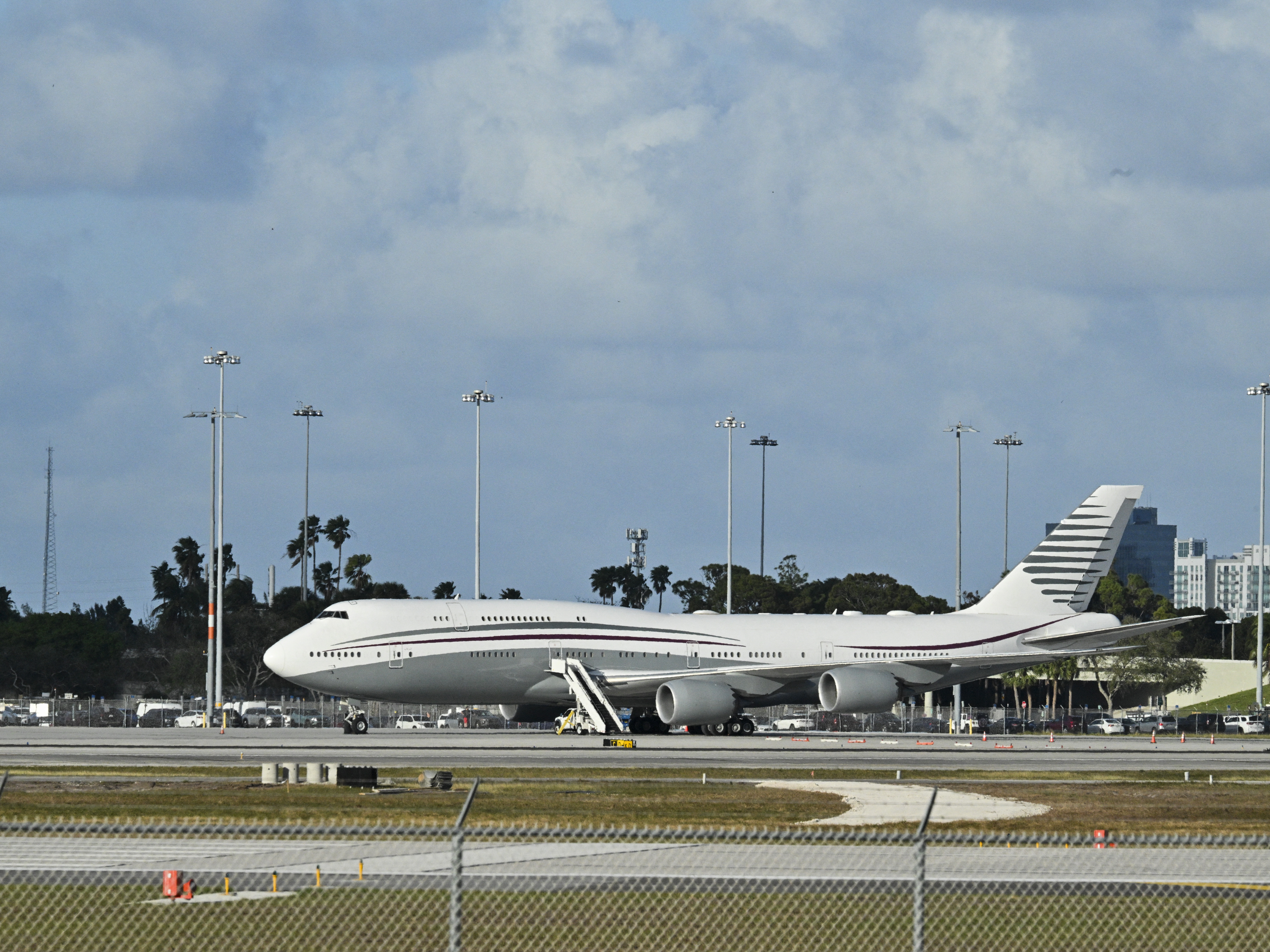 caption: A Qatari Boeing 747 sits on the tarmac of Palm Beach International airport after President Trump toured the aircraft on Feb. 15. The aircraft is now in San Antonio and needs extensive overhauling to become the next Air Force One.