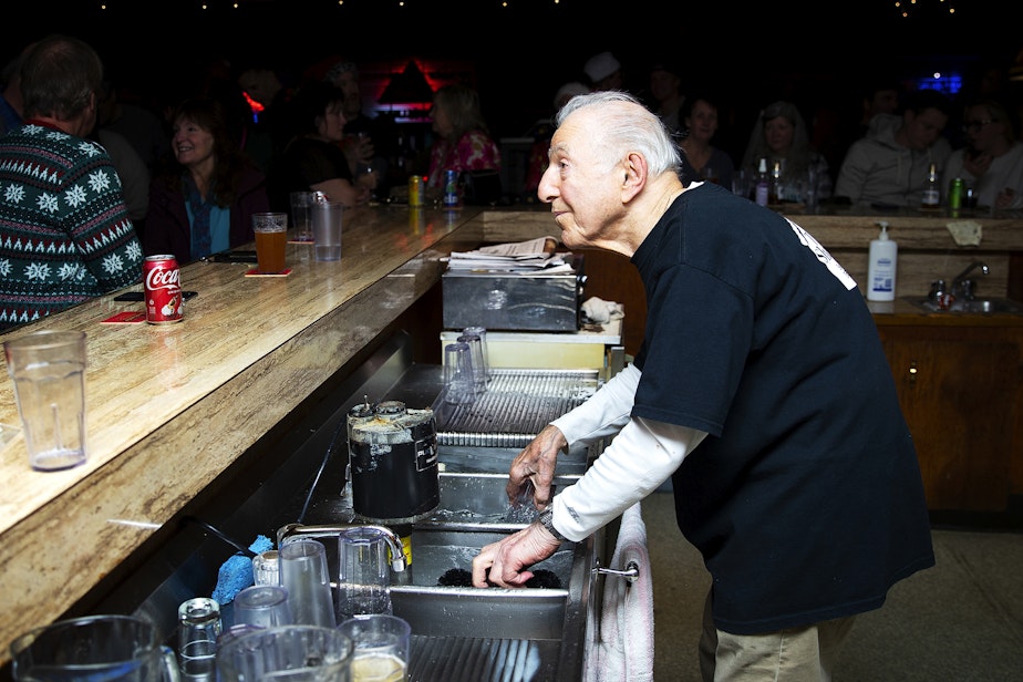 caption: John Spaccarotelli, 94-year-old owner and bartender at what many call the ‘last roadhouse in Seattle,’ tends bar on Friday, December 19, 2025, at the Shanty Tavern in Lake City.
