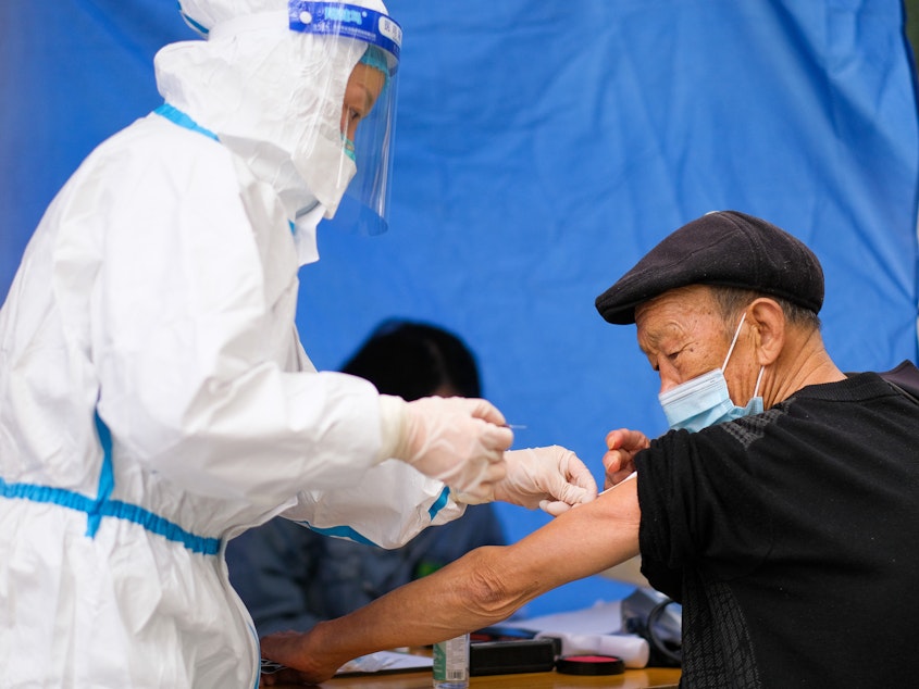 caption: An older adult receives a COVID-19 vaccine at a temporary vaccination site on Dec. 7 in Chongqing, China. Concerns about effectiveness and safety have led to uncertainty about the COVID vaccine, notably among older citizens, whose vaccination rate is relatively low.