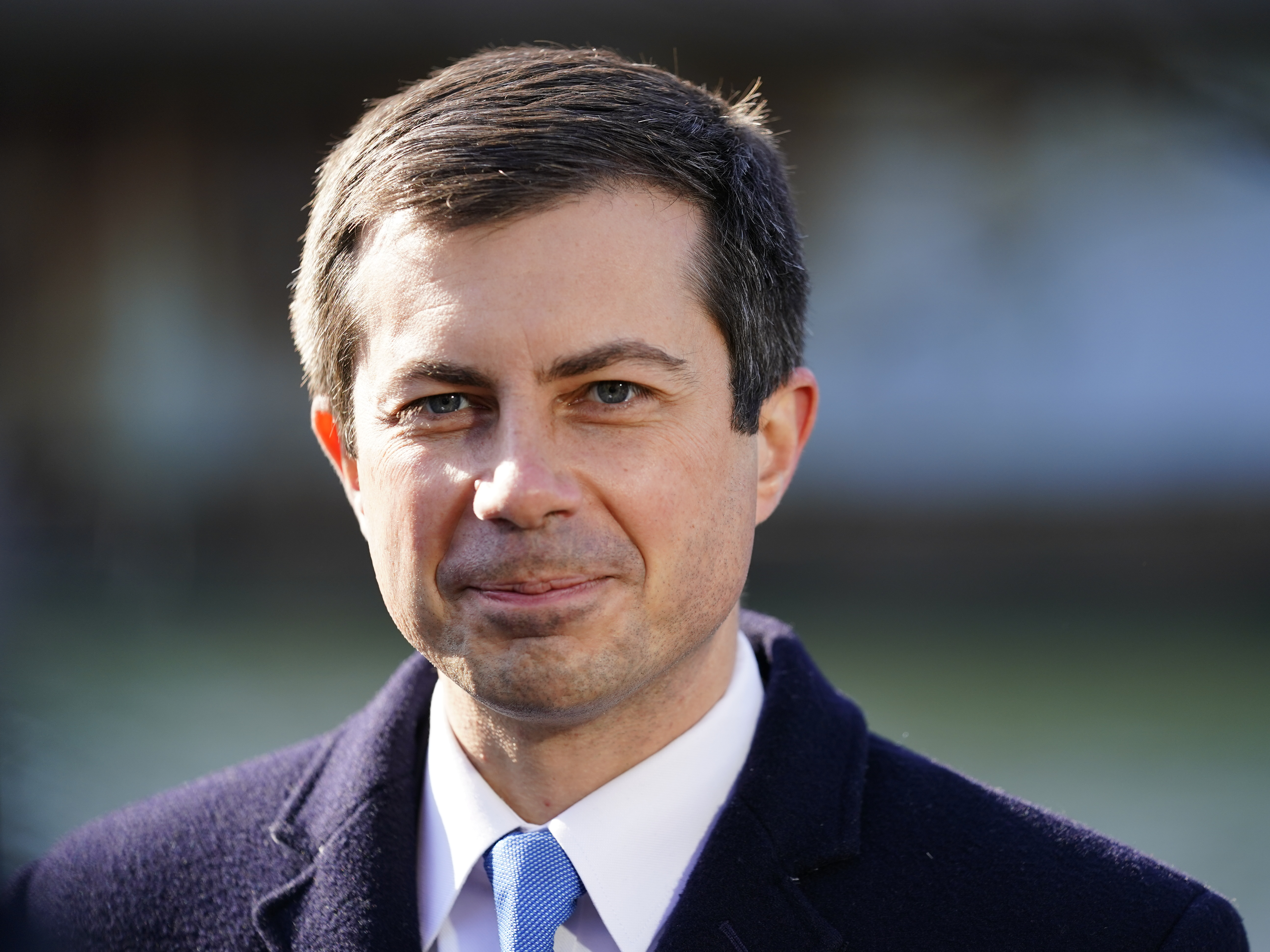 caption: Transportation Secretary Pete Buttigieg listens at an event in Philadelphia, on Jan. 14, 2022.