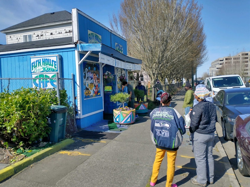 caption: Customers line up outside the Fish House Cafe on MLK Jr Way in Tacoma's Hilltop neighborhood