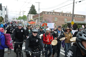 caption: Immigrant rights march heads into downtown Seattle.