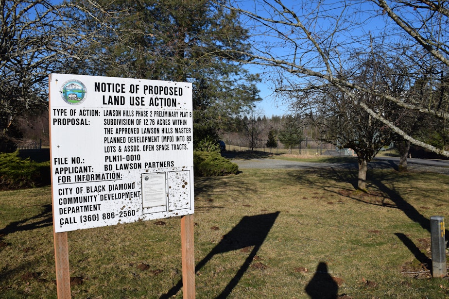 caption: Notice of Proposed Land Use Action signs are ubiquitous in Black Diamond. The planned development will eventually bring 6,000 new homes to the area.