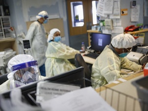 caption: Emergency room doctors and nurses work on Monday at St. Joseph's Hospital in Yonkers, N.Y. New York has seen the most coronavirus-related deaths of any state.