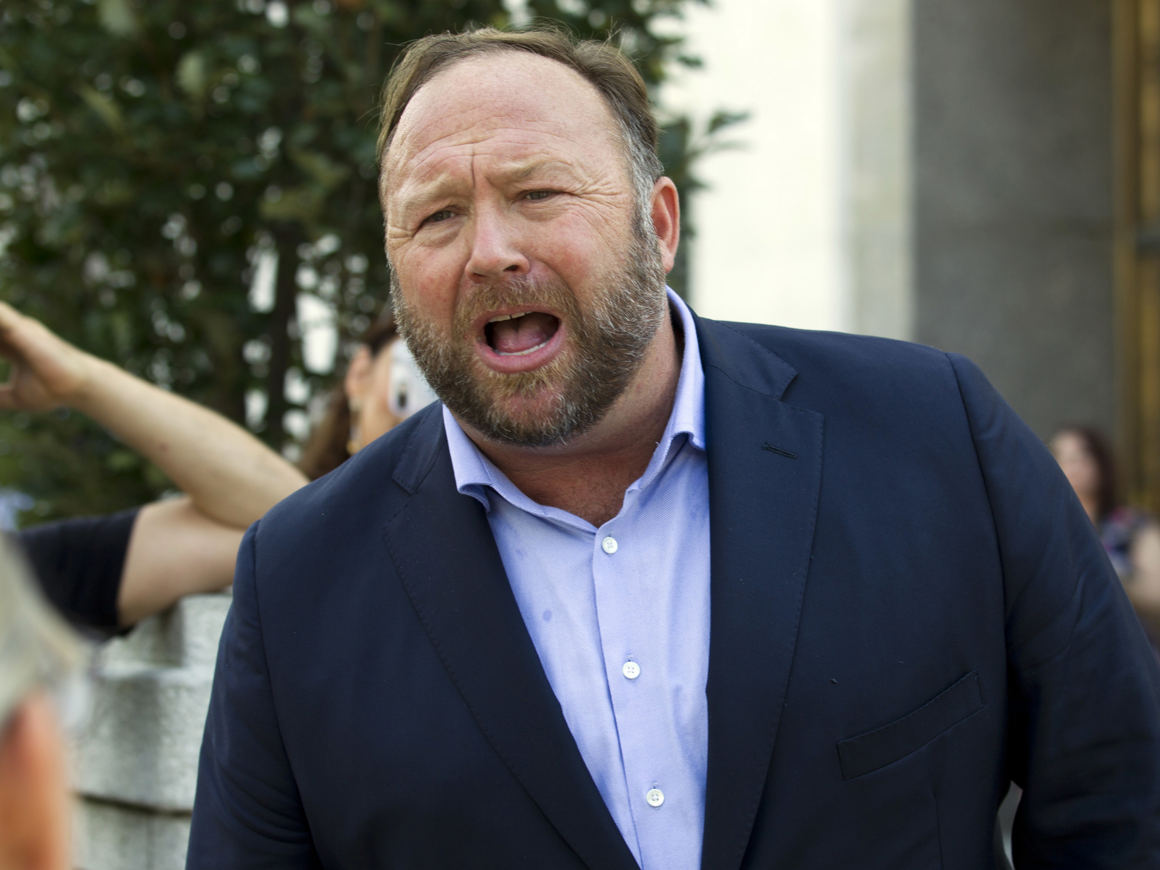 caption: Conspiracy theorist Alex Jones speaks outside of the Dirksen building of Capitol Hill in Washington in September of last year.