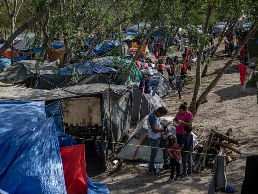 caption: Clothing hangs to dry at a makeshift migrant camp for asylum seekers in Matamoros, Tamaulipas state, Mexico, on earlier this month. About 60,000 migrants live in filthy and dangerous conditions as they await their day in U.S. immigration court.