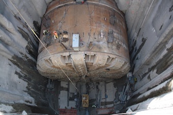 caption: Workers will cut Bertha's exoskeleton into three pieces for easier removal. They plan to lift those pieces and Bertha's much heavier cutter head to the surface by the end of March.