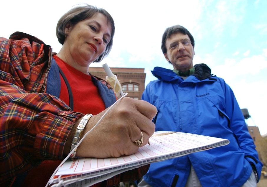 caption: Mary Champine, left, adds her signature to a petition in Washington state (file photo).