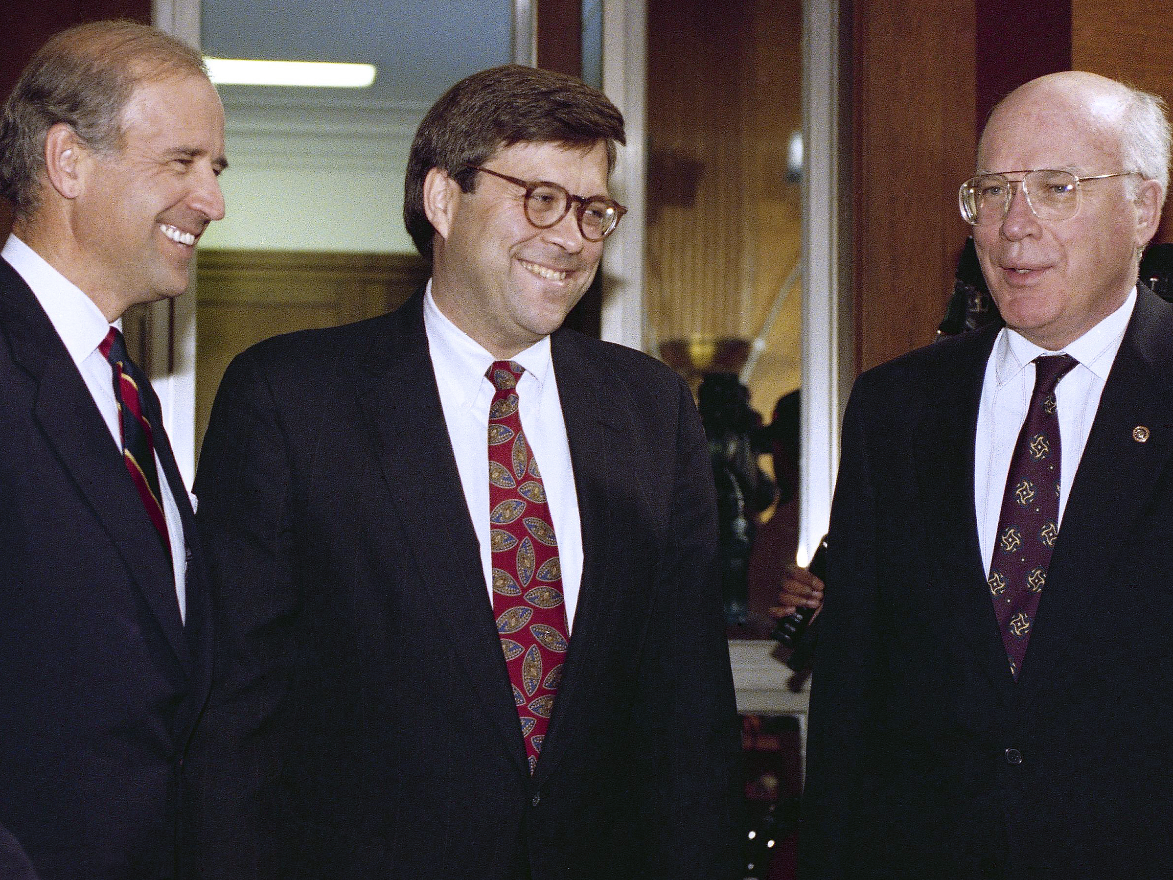 caption: Attorney General nominee William Barr (center) chats with then-Sen. Joe Biden and Sen. Patrick Leahy, D-Vt., before Barr's hearing on Nov. 12, 1991.