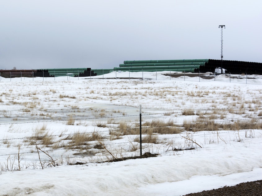 caption: This March 11, 2020 photo provided by the Bureau of Land Management shows a storage yard in Montana for pipe that was to be used in construction of the Keystone XL oil pipeline. The developer has now canceled the controversial project.