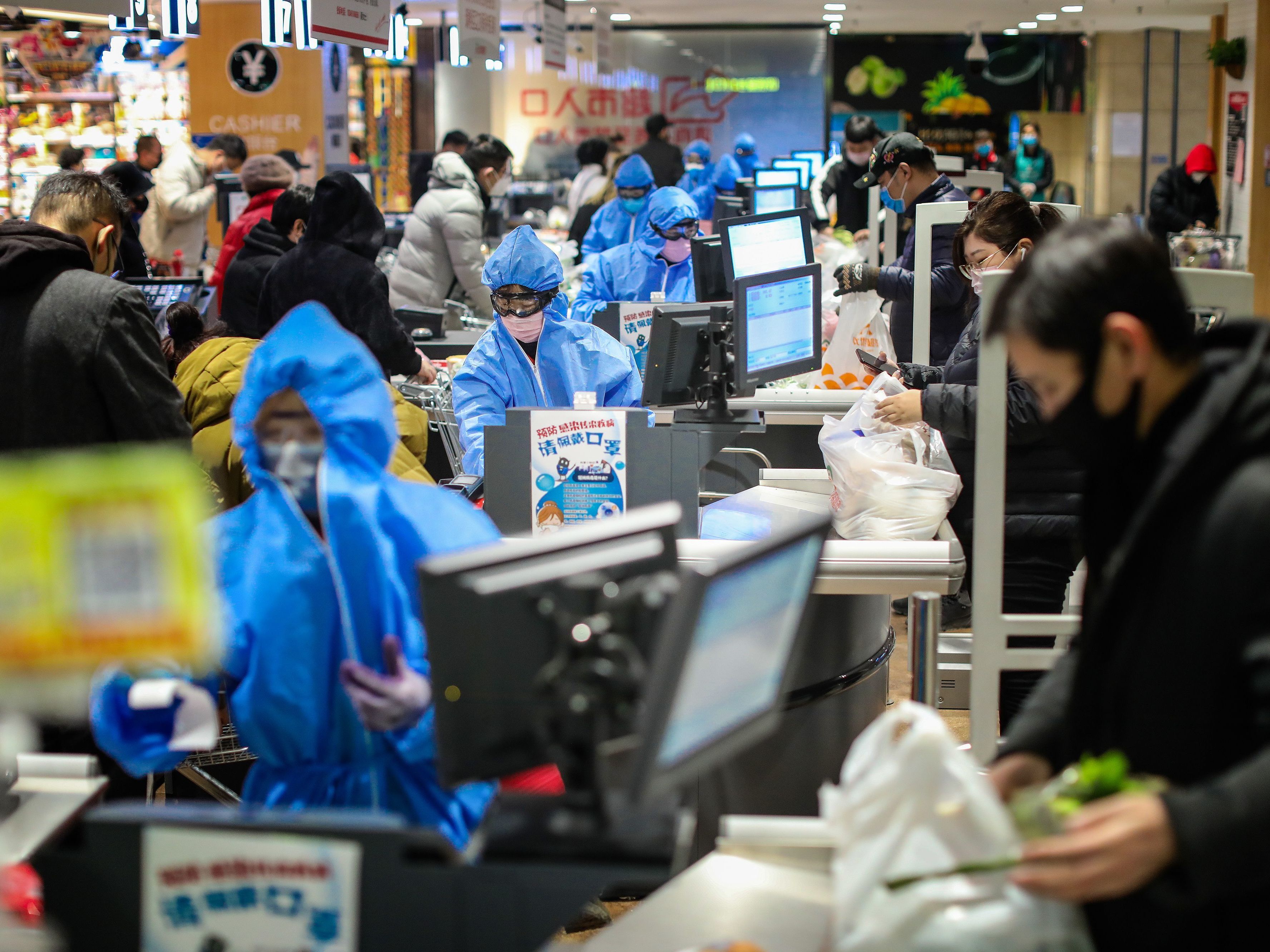 caption: People wearing protective masks shopping at a supermarket in Shenyang in China's northeastern Liaoning province, on Monday.