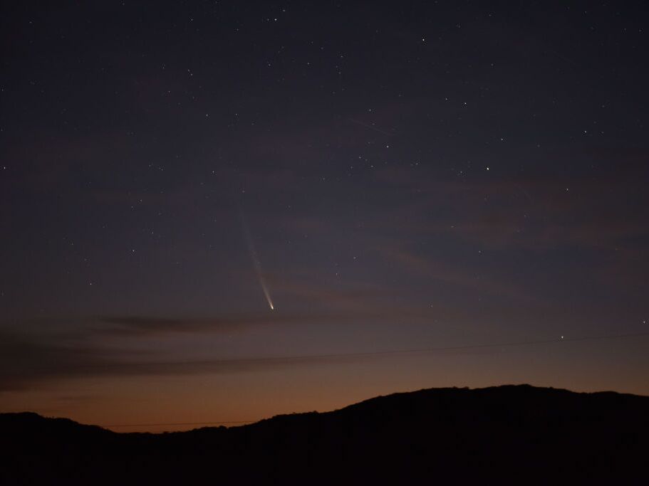 caption: Comet C/2023 A3 Tsuchinshan-Atlas is seen over the hills near the village of Aguas Blancas, Lavalleja Department, Uruguay, at dawn on Sept. 28,.