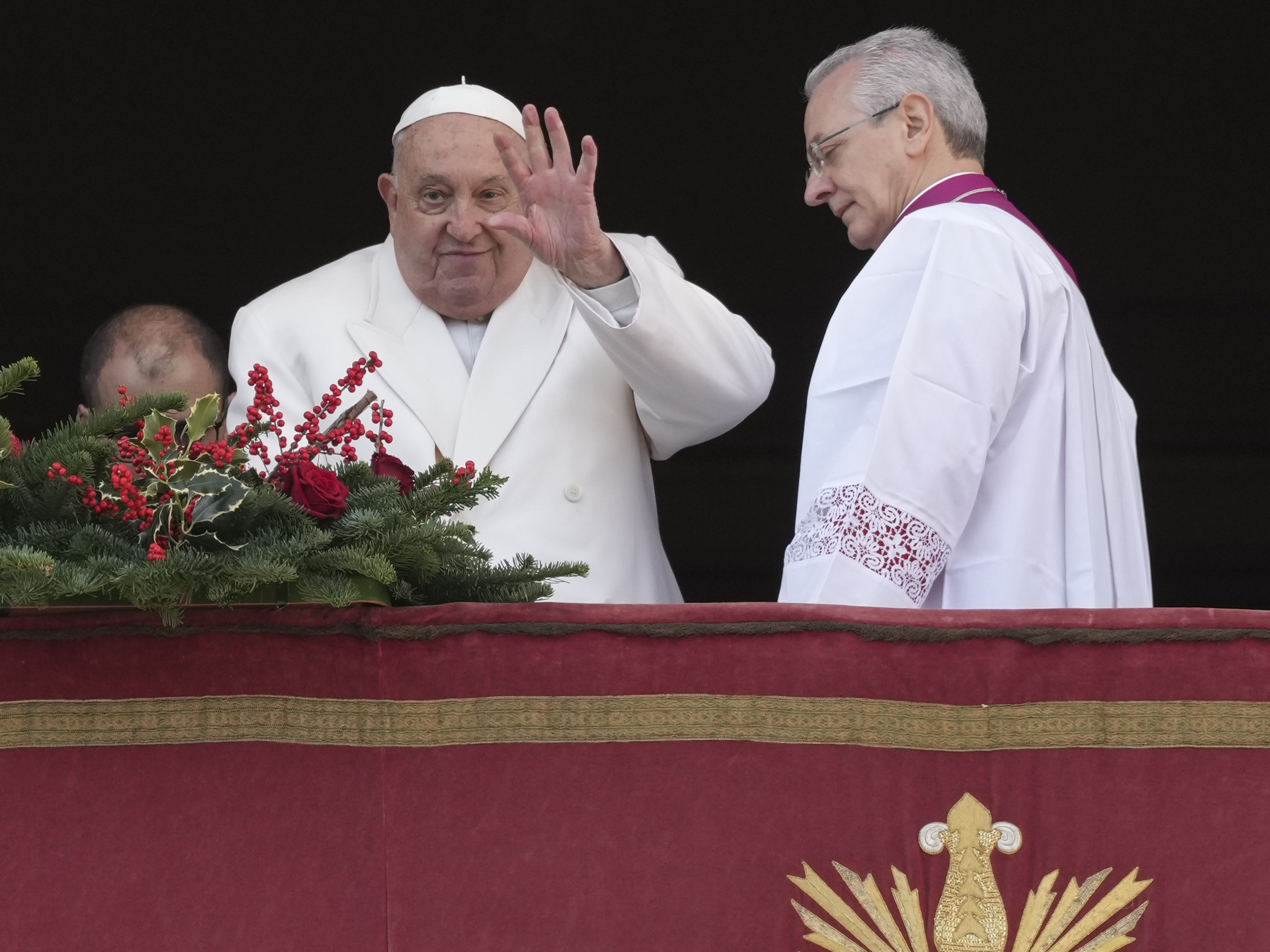caption: Pope Francis waves before delivering the Urbi et Orbi (Latin for 'to the city and to the world' ) Christmas' day blessing from the main balcony of St. Peter's Basilica at the Vatican, Wednesday, Dec. 25, 2024.