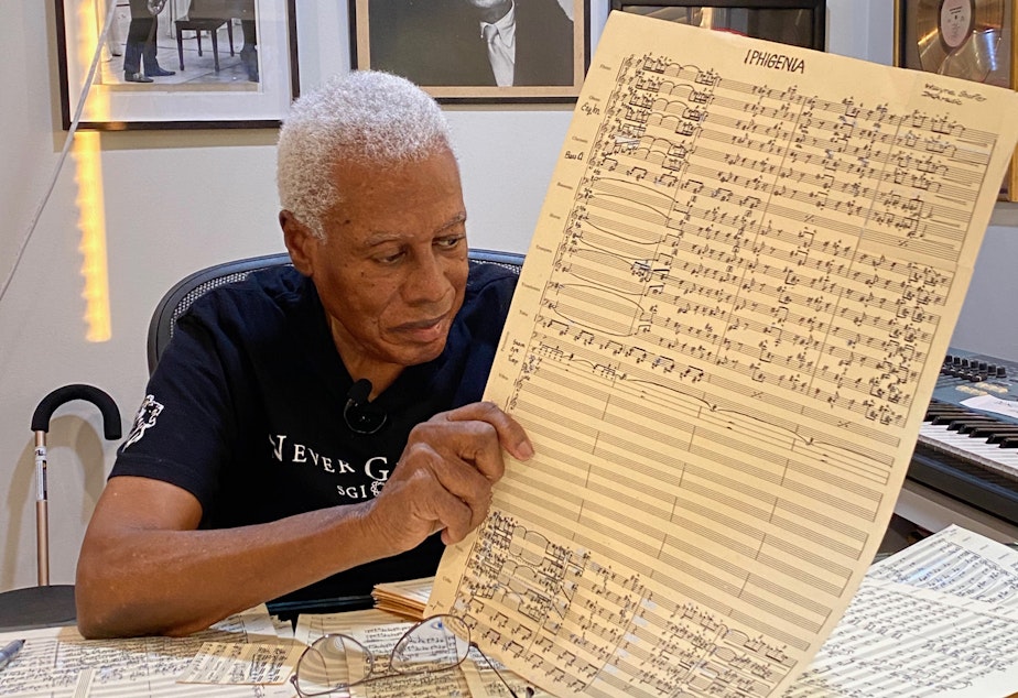 caption: Composer and saxophonist Wayne Shorter with a page from his <em>...(Iphigenia)</em> score.