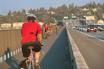 caption: A cycle track puts a physical barrier between bicyclists and car traffic.