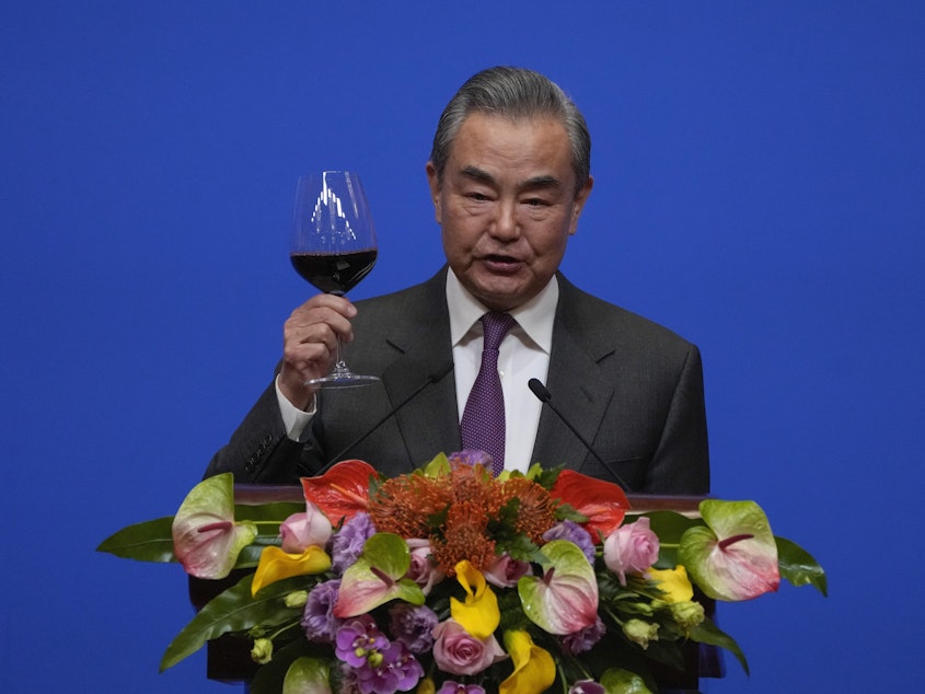 caption: Chinese Foreign Minister Wang Yi gives a toast to invited guests after delivering a speech at a reception for Commemoration of the 45th Anniversary of China-U.S. Diplomatic Relations in Beijing on Friday.