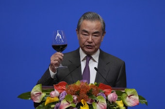 caption: Chinese Foreign Minister Wang Yi gives a toast to invited guests after delivering a speech at a reception for Commemoration of the 45th Anniversary of China-U.S. Diplomatic Relations in Beijing on Friday.