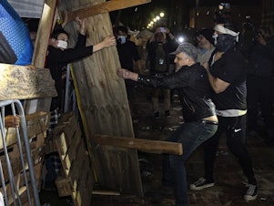 caption: Counterprotesters try to dismantle a pro-Palestinian encampment set up on the University of California, Los Angeles campus in the early hours of Wednesday.