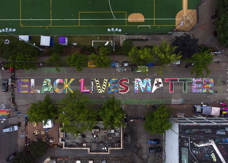 caption: FILE: The block-long Black Lives Matter street mural, beginning at 10th Avenue and East Pine Street, is shown on Saturday, June 13, 2020, inside the area known as the Capitol Hill Occupied Protest, or CHOP, in Seattle.
