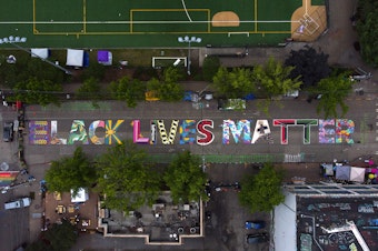 caption: FILE: The block-long Black Lives Matter street mural, beginning at 10th Avenue and East Pine Street, is shown on Saturday, June 13, 2020, inside the area known as the Capitol Hill Occupied Protest, or CHOP, in Seattle.