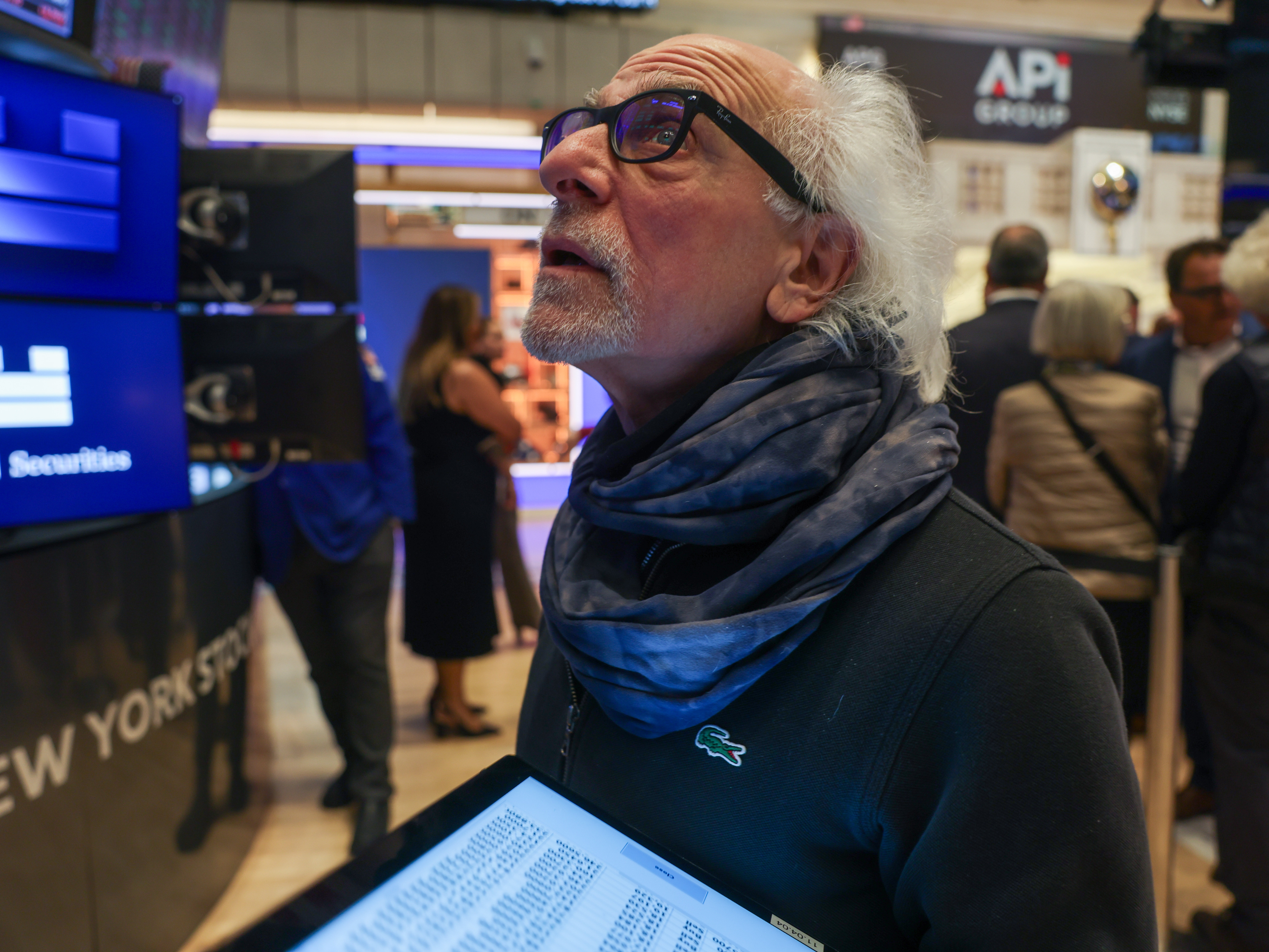 caption: Traders work on the floor of the New York Stock Exchange.