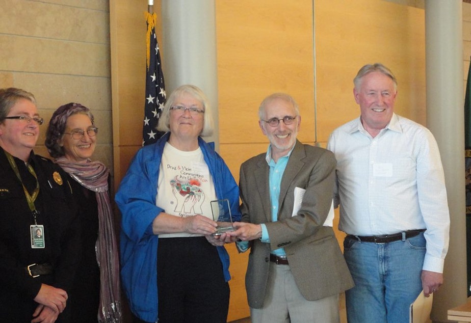 caption: Jean Darsie receives the Innovative Program Award from the Seattle Human Services Coalition in 2013 at Seattle City Hall from then-City-Councilmember Nick Licata. Bill Kirlin-Hackett is on the right, Laura Fox and Elizabeth Maupin on the left