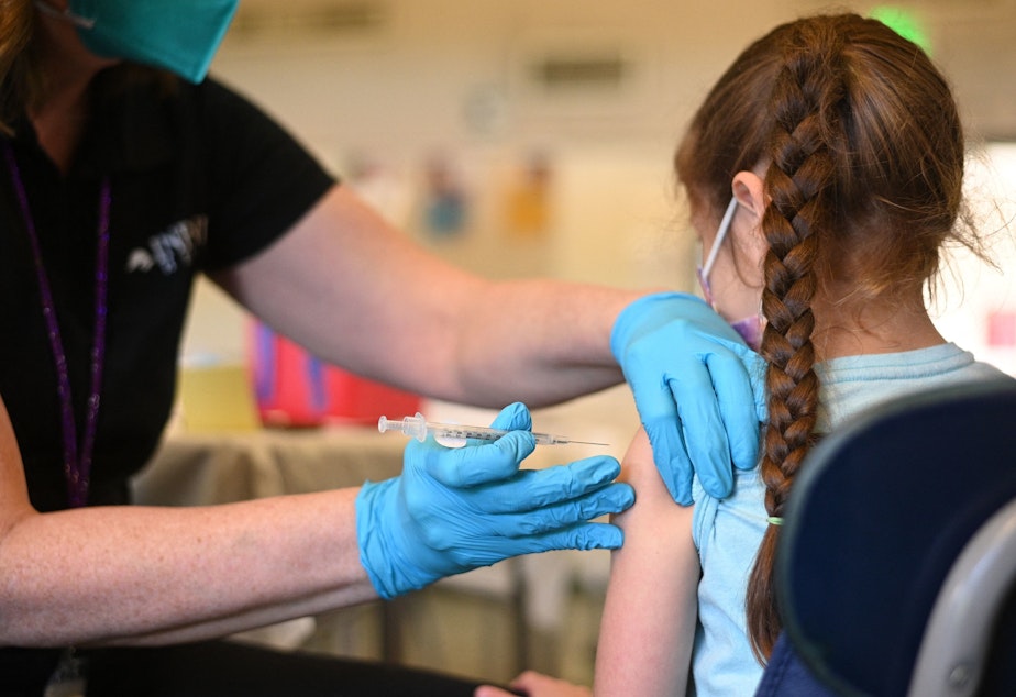 caption: A nurse administers a pediatric dose of the Covid-19 vaccine to a girl at a L.A. Care Health Plan vaccination clinic at Los Angeles Mission College in the Sylmar neighborhood in Los Angeles, Ca., January 19, 2022.