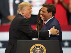 caption: Then-President Donald Trump greets then-Florida Republican gubernatorial candidate Ron DeSantis during a campaign rally at the Hertz Arena on Oct. 31, 2018 in Estero, Fla. In 2024, the two candidates may run against one another for president.