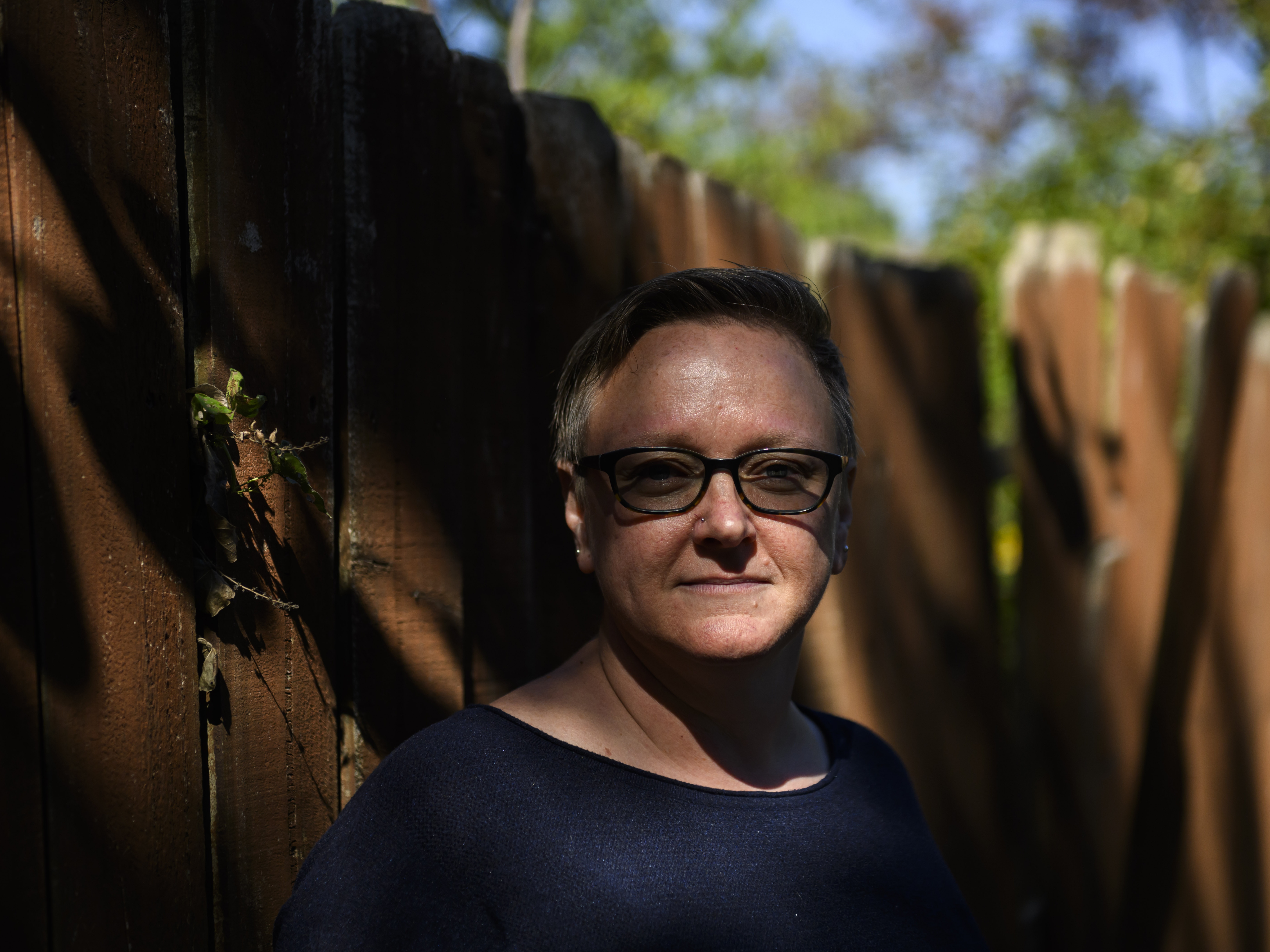 caption: Natalie Donaldson, an Army veteran, poses for a portrait at her home in Tulsa, Okla. A COVID assistance program that was supposed to help her avoid foreclosure ended up increasing her mortgage payments by 50% every month.