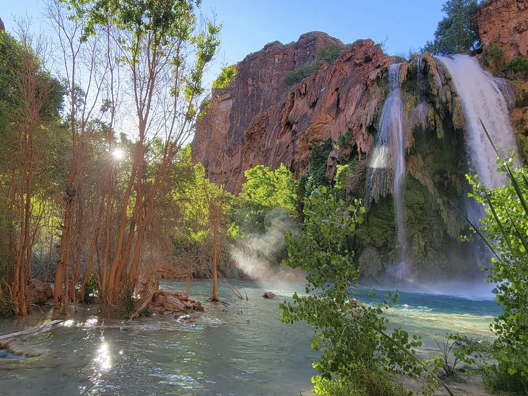 caption: A photo shows Mooney Falls on the Havasupai reservation in Arizona in May. Dozens of tourists say they fell ill on a recent visit to a popular and picturesque stretch of waterfalls deep in a gorge neighboring Grand Canyon National Park.