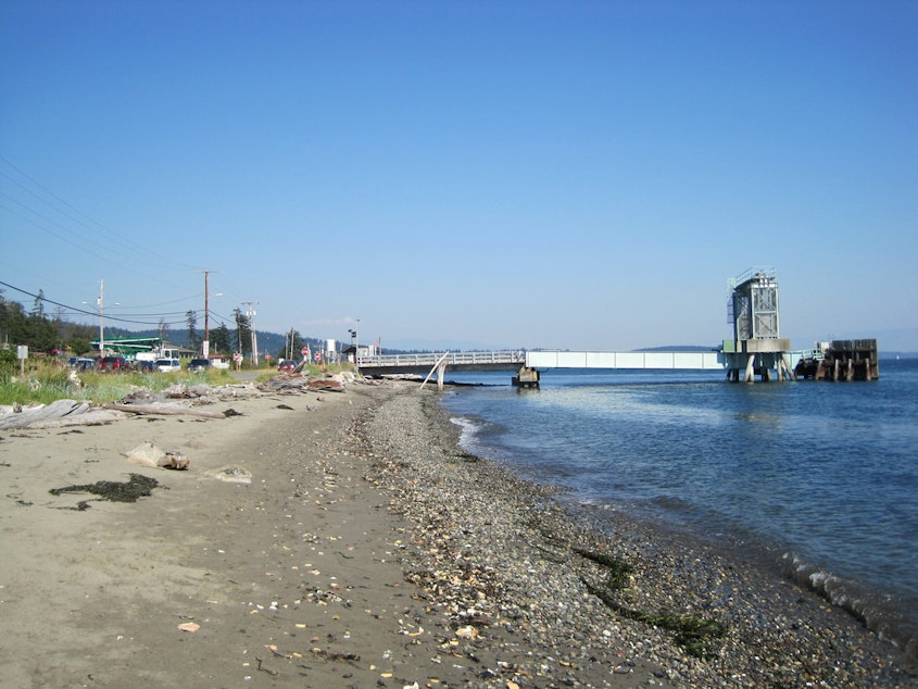 caption: View of the Guemes Island ferry dock from the beach. The Guemes Island ferry is Skagit County's only ferry, with 20 runs a day.