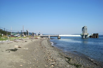 caption: View of the Guemes Island ferry dock from the beach. The Guemes Island ferry is Skagit County's only ferry, with 20 runs a day. 