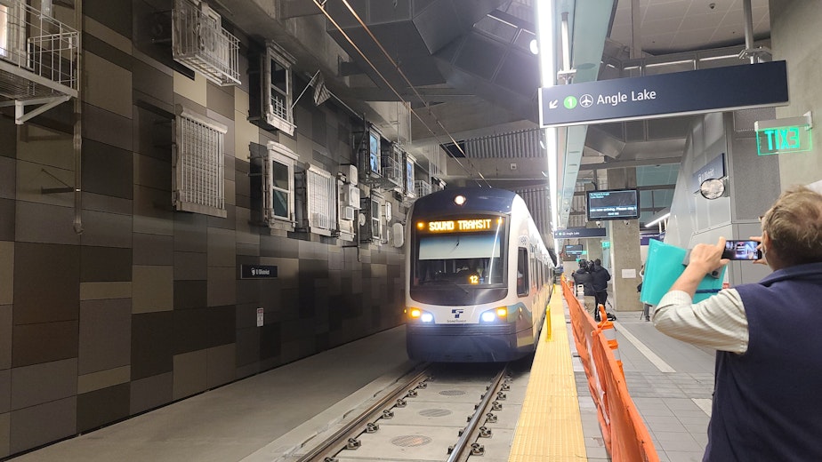 caption: The Sound Transit light rail is conducting final test runs inside the new U-District station.