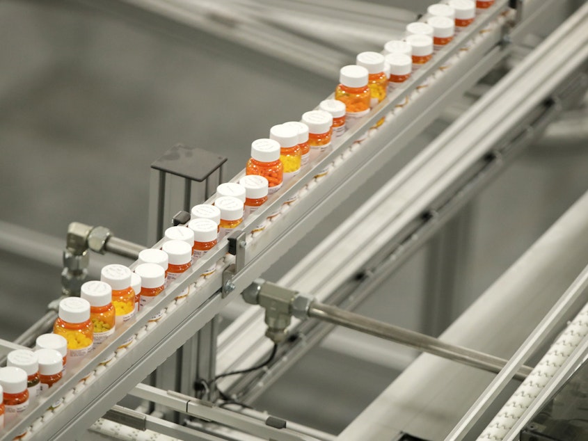 caption: Bottles of medicine ride on a belt at the Express Scripts mail-in pharmacy warehouse in Florence, N.J., in 2018. Democratic lawmakers have reached a deal to lower prescription drug prices for seniors.
