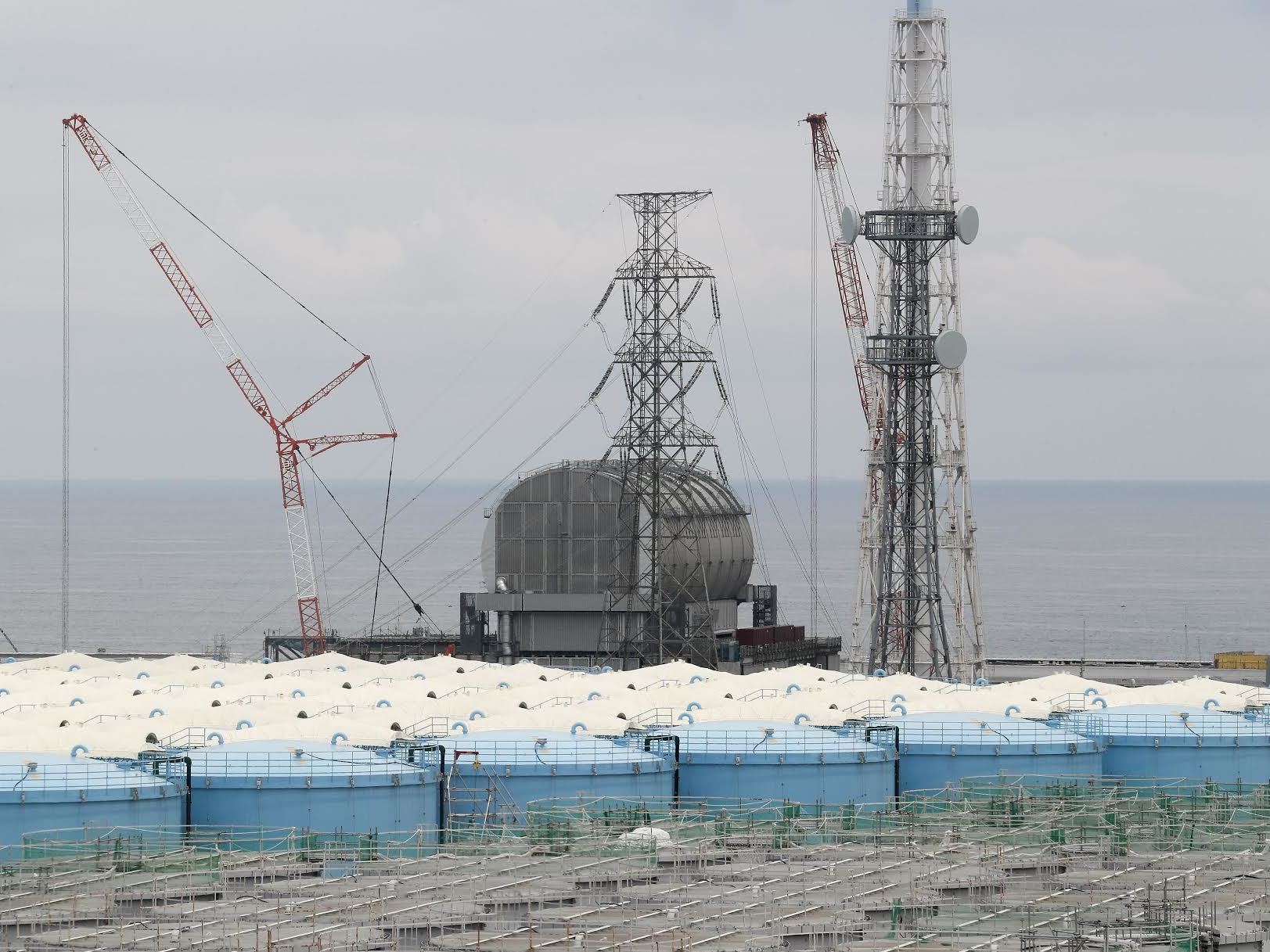 caption: Prosecutors say TEPCO leaders should have known the risks a tsunami could pose to the Fukushima Dai-ichi nuclear power plant, which sits along Japan's eastern coast. Here, the Unit 3 reactor is seen this past summer, amid storage tanks of radiation-contaminated water.