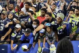 caption: Fans call for autographs after an NFL football preseason game between the Seattle Seahawks and the Los Angeles Chargers, Saturday, Aug. 28, 2021, in Seattle. The Seahawks won 27-0. 
