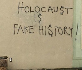 caption: Vandalism found by an off-duty officer on the walls of Temple De Hirsch Sinai on March 11. Rabbi Daniel Weiner wanted to keep the graffiti in place to show this ugliness to the world.