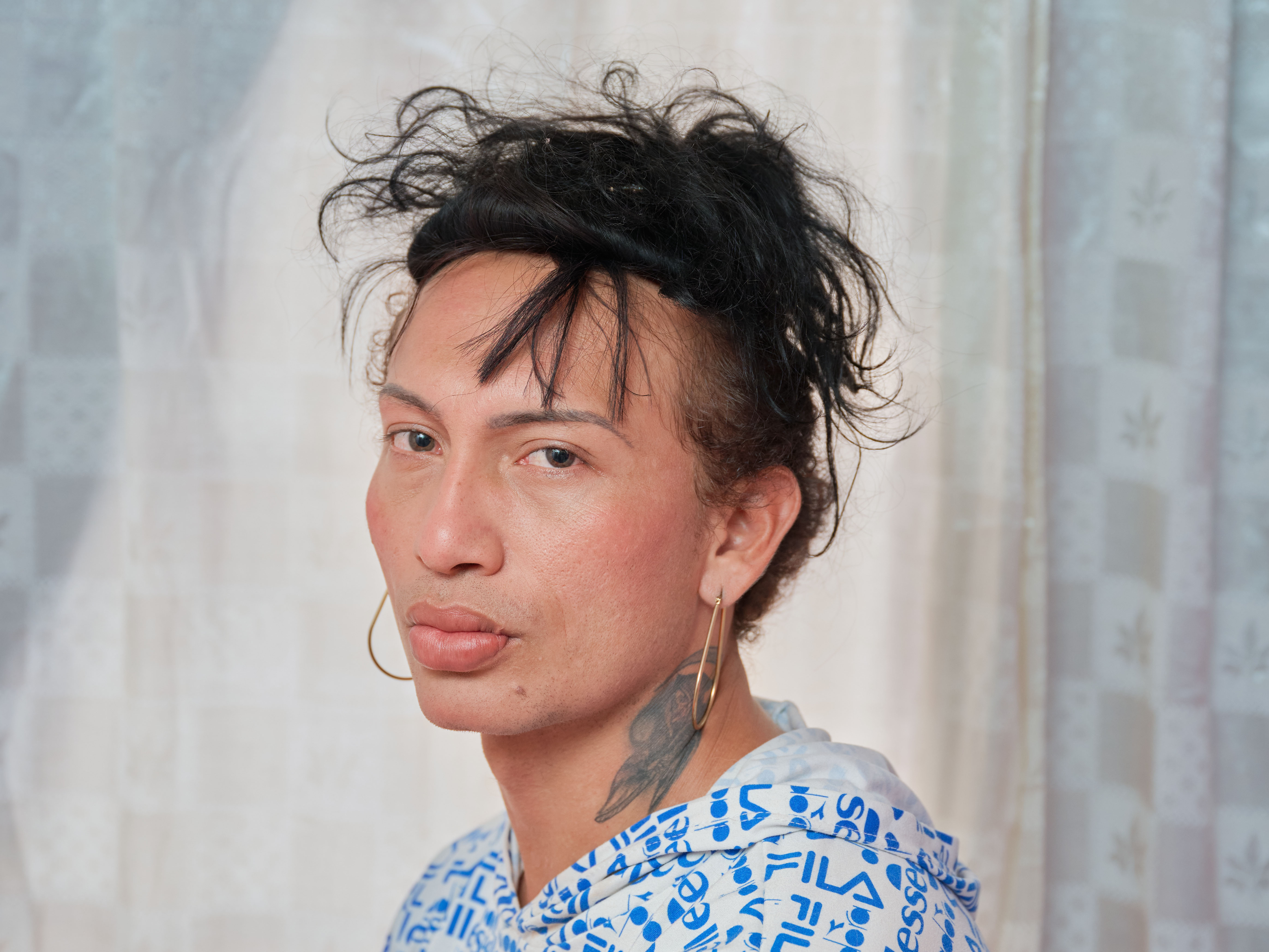 caption: Charloth Chirino poses for a portrait in her apartment in Medellín. Originally from Maracaibo, Venezuela, Charloth has been living in Colombia for seven years, three of those in Medellín. She has lived her life as a proud trans woman since she was 15 years old, when she also began working as a sex worker.