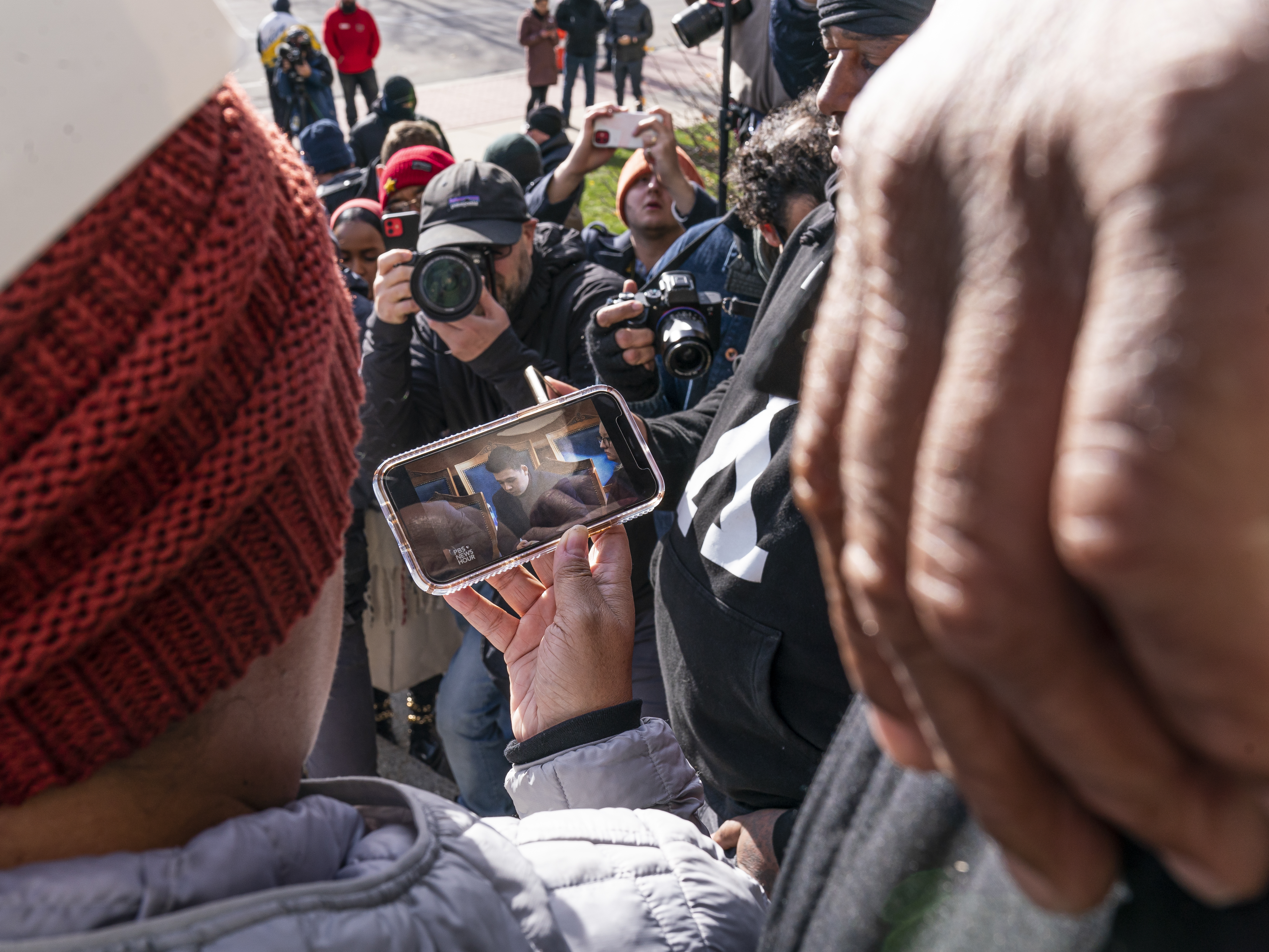caption: Bystanders on the steps of the courthouse watch as the verdict is read in the trial of Kyle Rittenhouse. Legal experts said Rittenhouse's claim of self-defense was strong from the beginning.