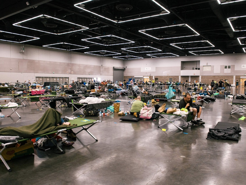 caption: People rest at a cooling station in Portland, Oregon during the deadly Northwest heat dome of 2021. Climate change has made heat risks more dangerous across the country. A new heat forecasting tool could help people stay safe.