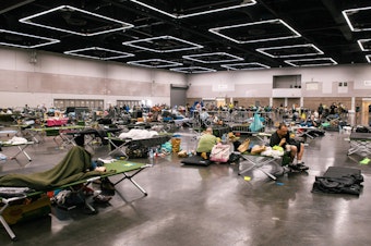 caption: People rest at a cooling station in Portland, Oregon during the deadly Northwest heat dome of 2021. Climate change has made heat risks more dangerous across the country. A new heat forecasting tool could help people stay safe.