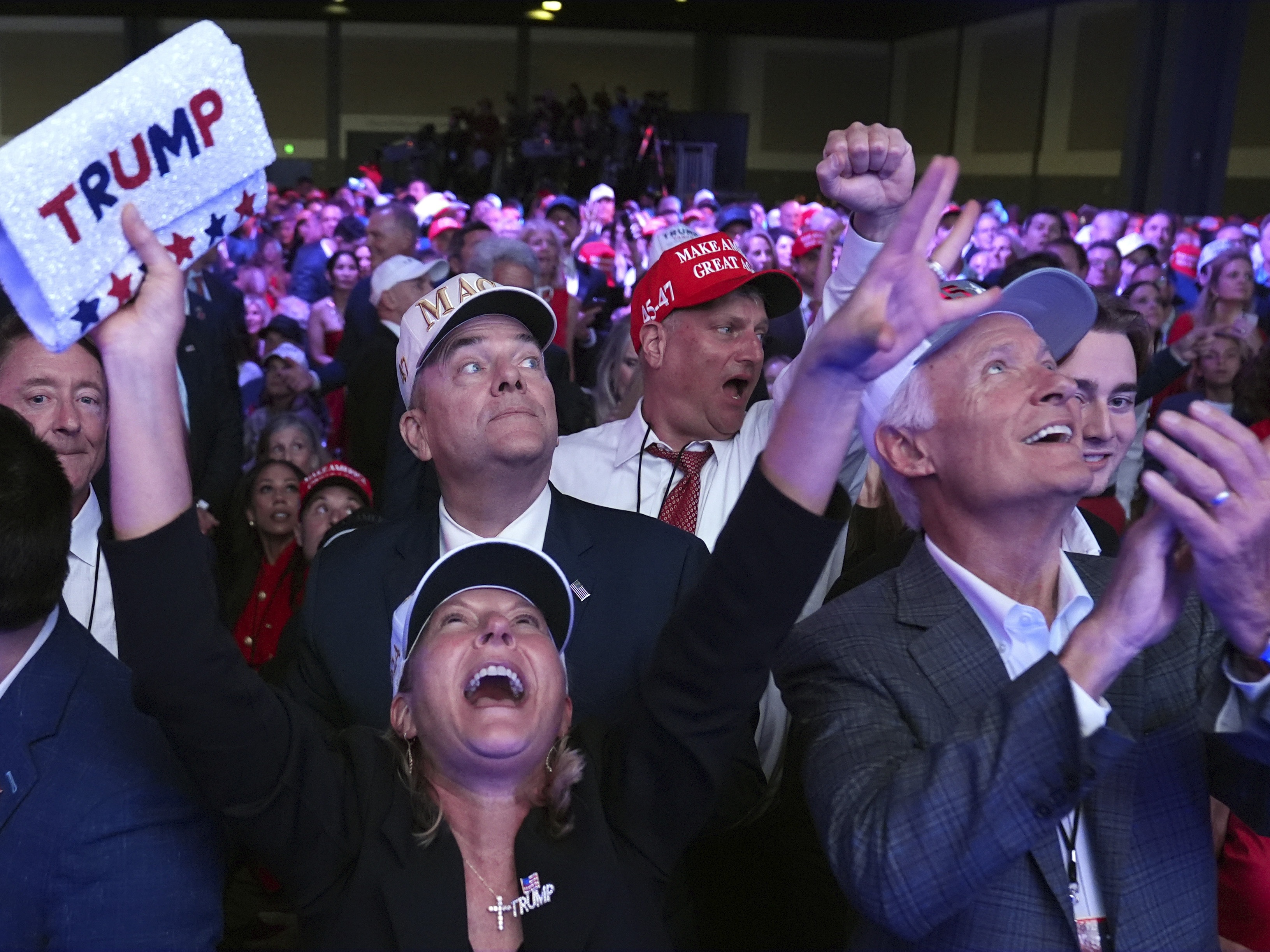 caption: Supporters watch returns at a campaign election night watch party for Republican presidential nominee former President Donald Trump at the Palm Beach Convention Center.