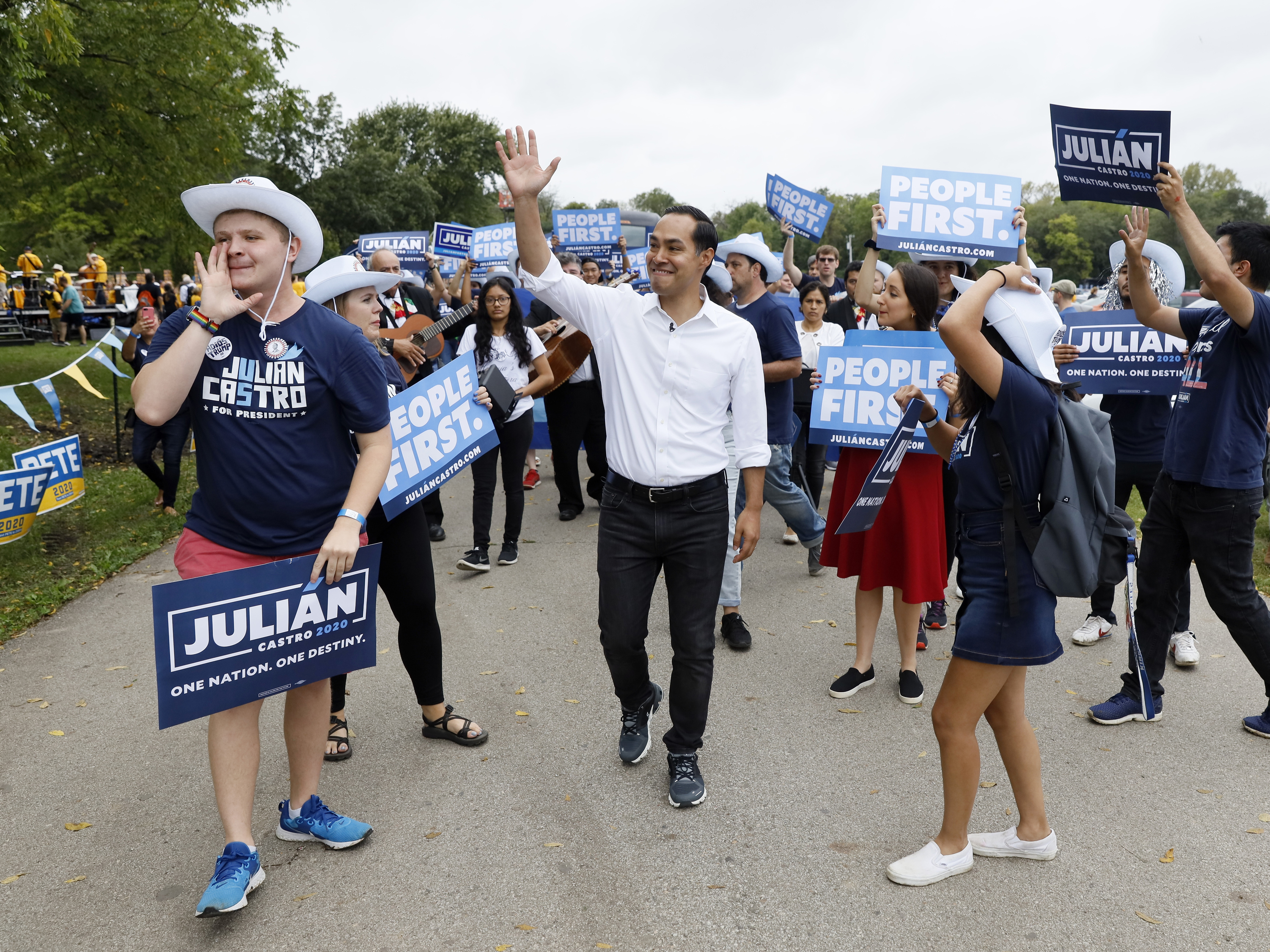 caption: Democratic presidential candidate and former U.S. Secretary of Housing and Urban Development Julián Castro marches with supporters during the Polk County Democrats Steak Fry, on Sept. 21, 2019, in Des Moines, Iowa.